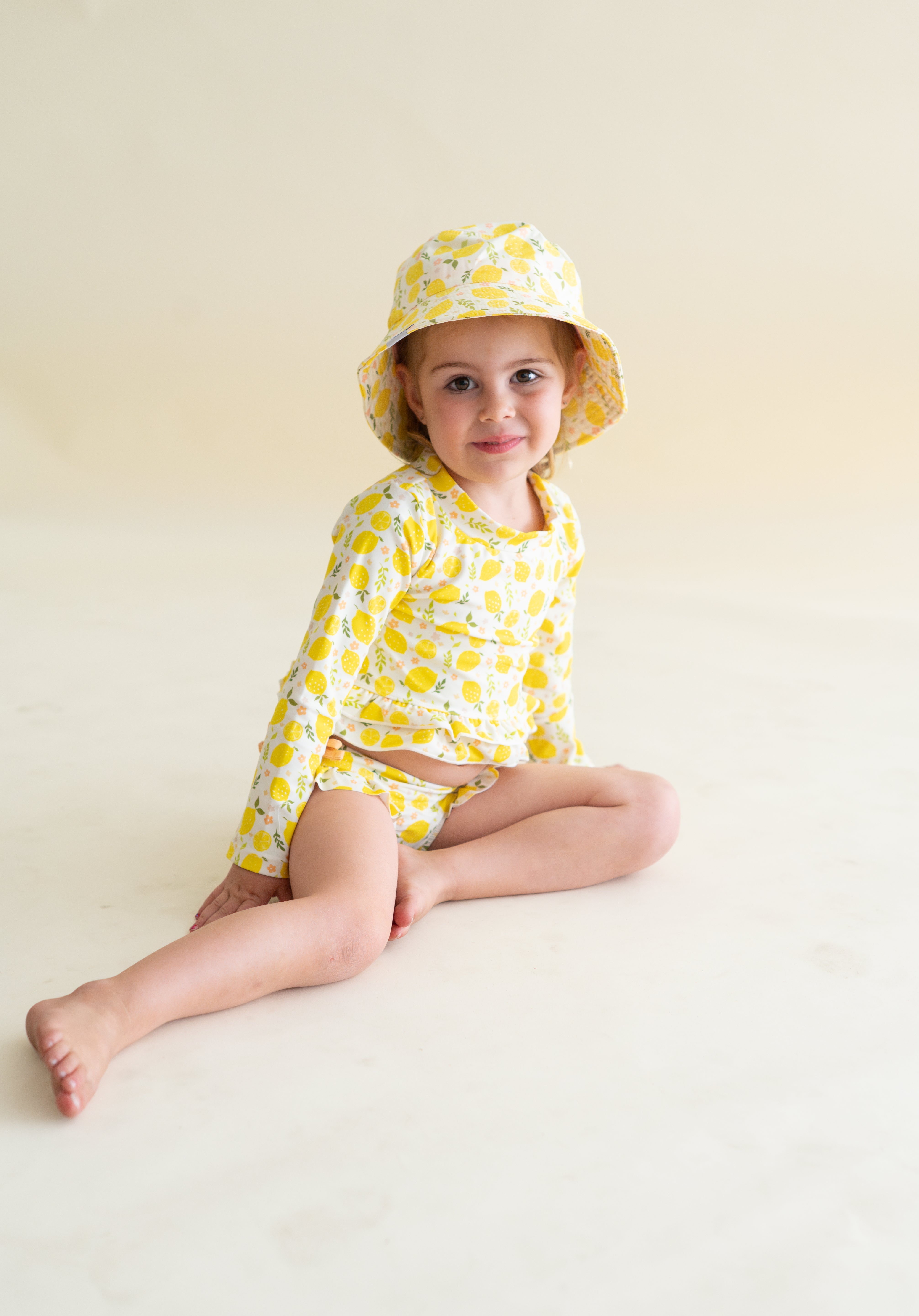 LEMON BLOSSOMS DREAM RASH GUARD RUFFLE TWO-PIECE SWIM SUIT