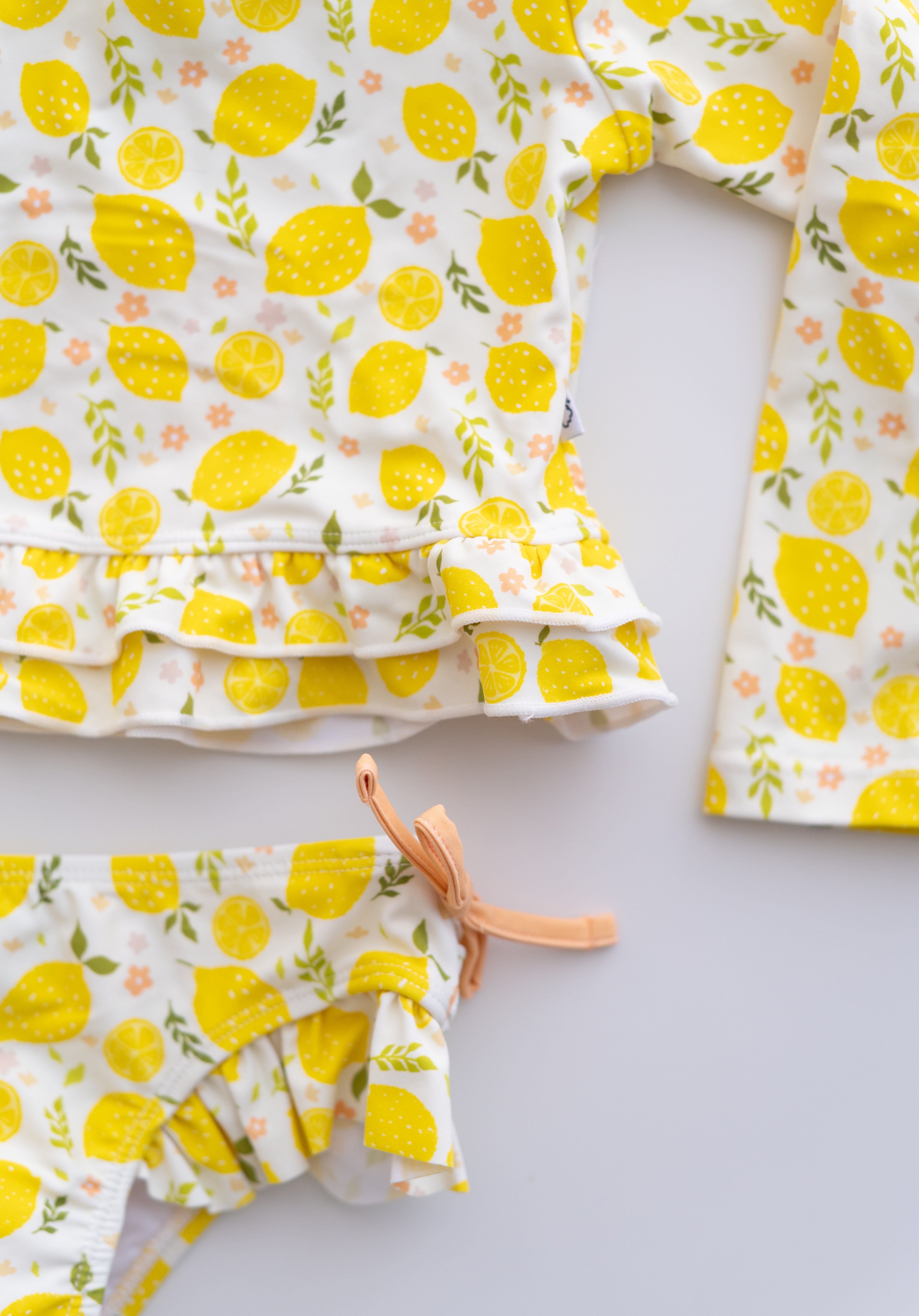LEMON BLOSSOMS DREAM RASH GUARD RUFFLE TWO-PIECE SWIM SUIT